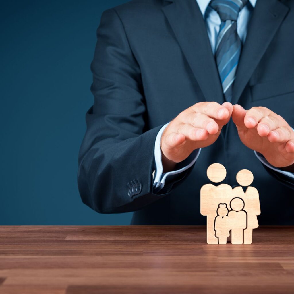 a fee based insurance advisor is holding his hands over a family to protect them.