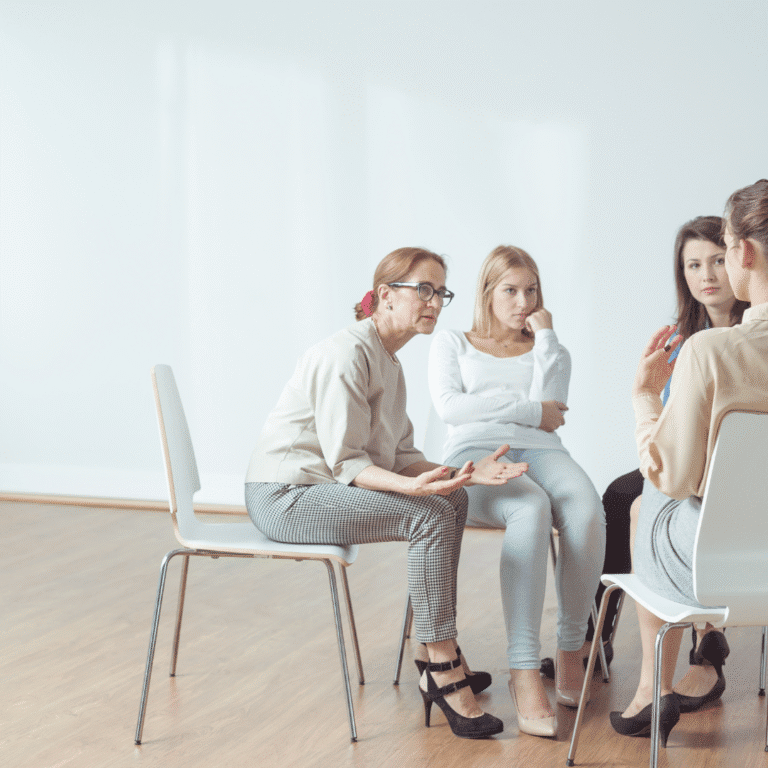 Group of women sitting in a circle during supportive mental health therapy session