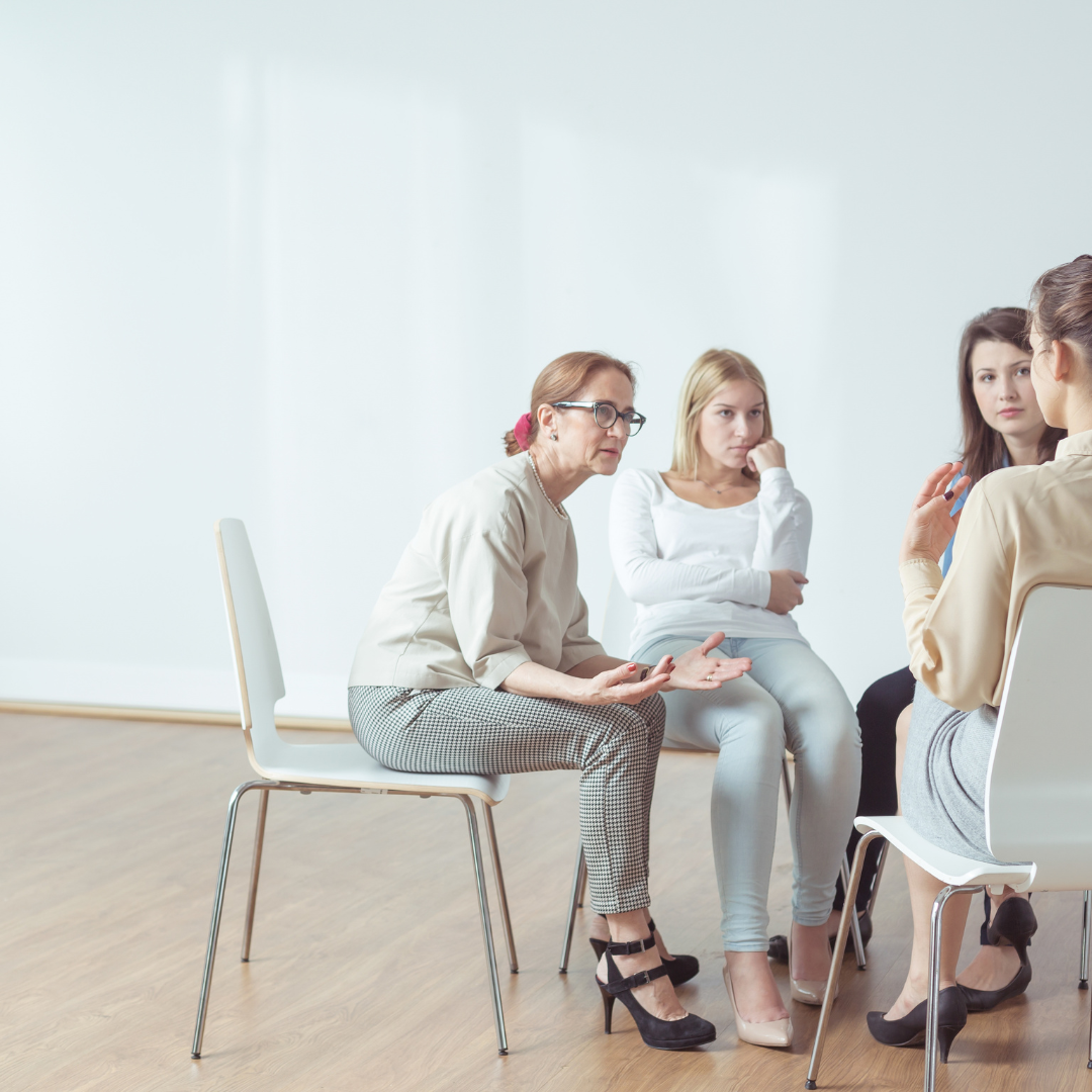 Group of women sitting in a circle during supportive mental health therapy session