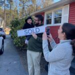 happy family with cute child outside their new home north of boston