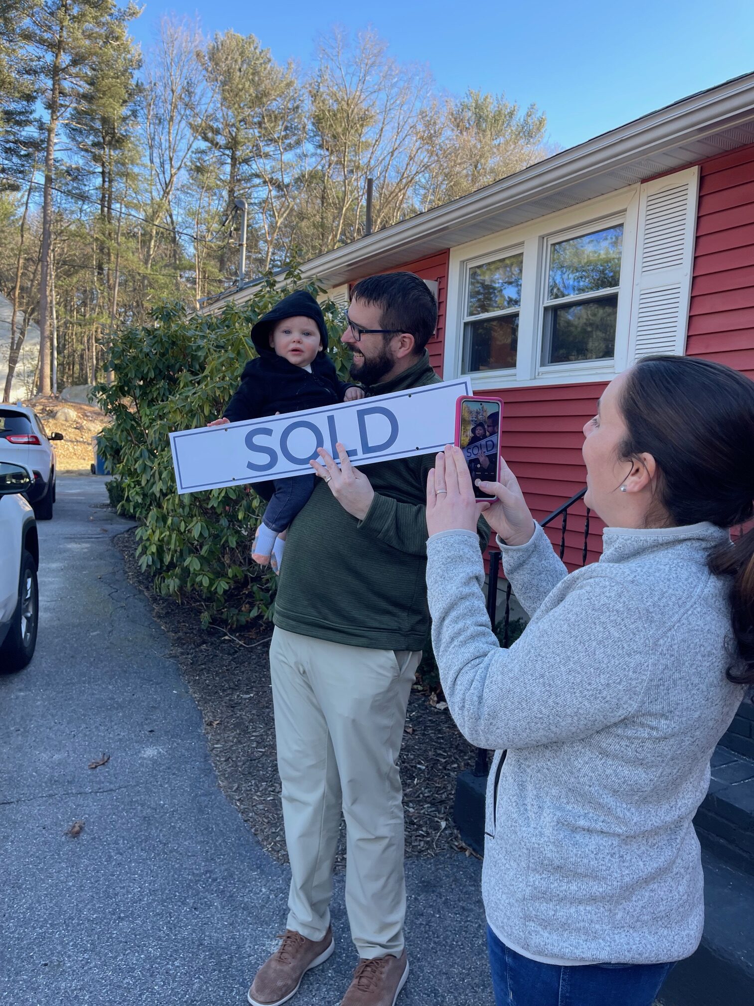 happy family with cute child outside their new home north of boston