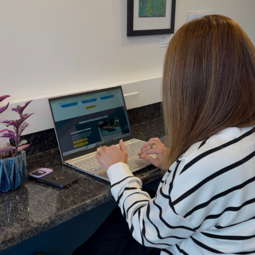 Website designer reviewing a small business website layout on a laptop during the design process